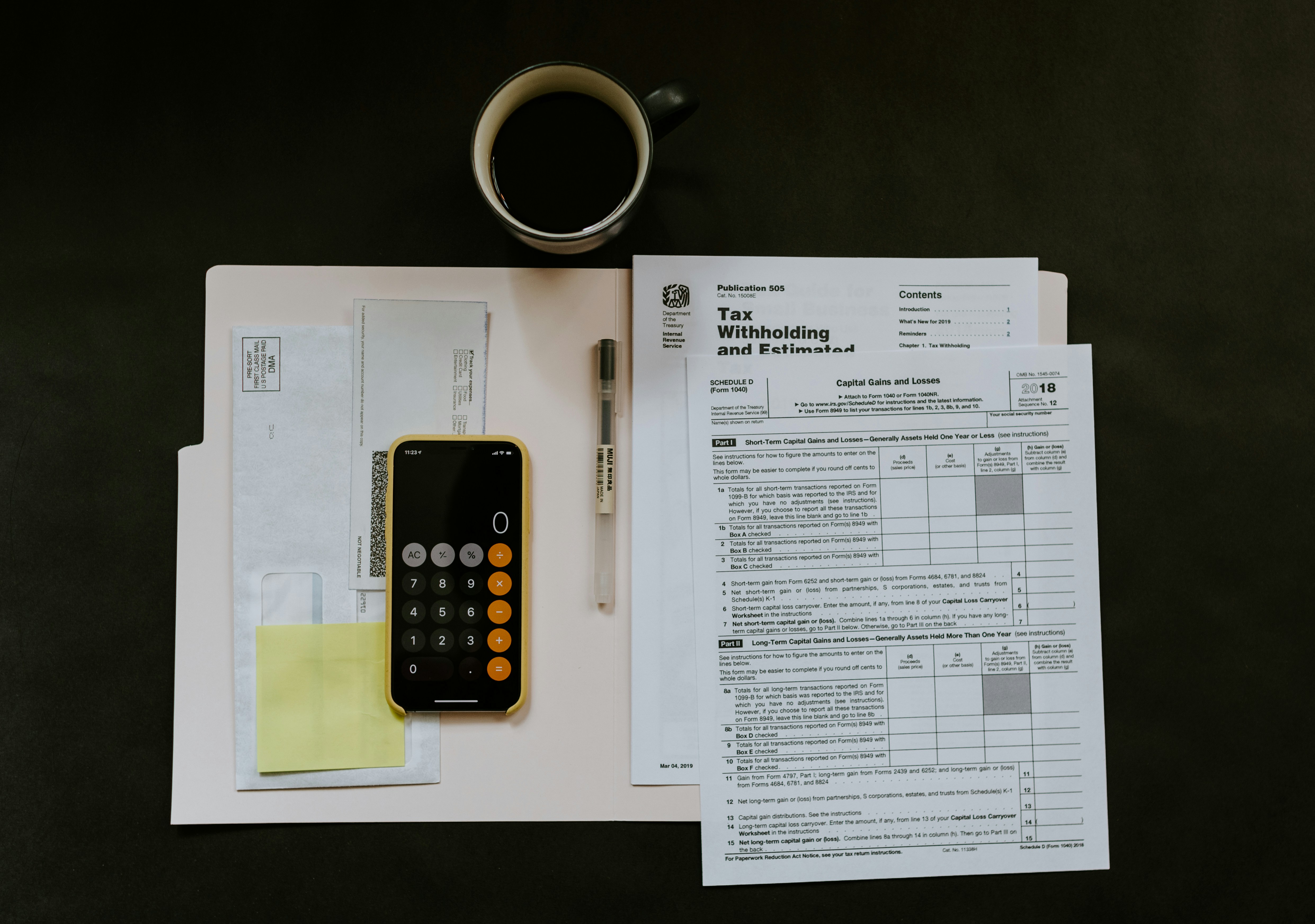 black Android smartphone near ballpoint pen, tax withholding certificate on top of white folder — por Kelly Sikkema no Unsplash